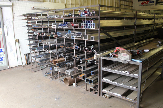 Photo of a steel rack with many different types of steel, taken at an angle.